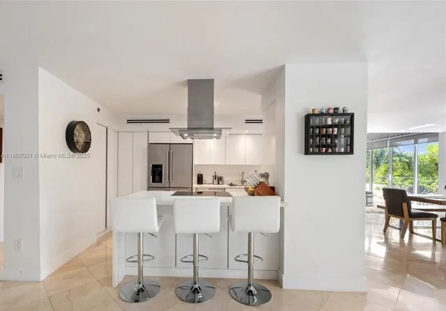 a kitchen with stainless steel appliances white cabinets and a refrigerator