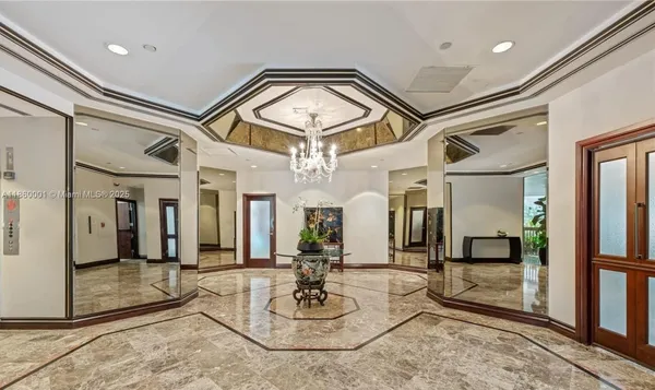 a lobby with furniture and a chandelier