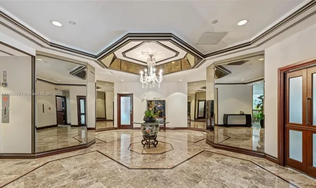 a lobby with furniture and a chandelier