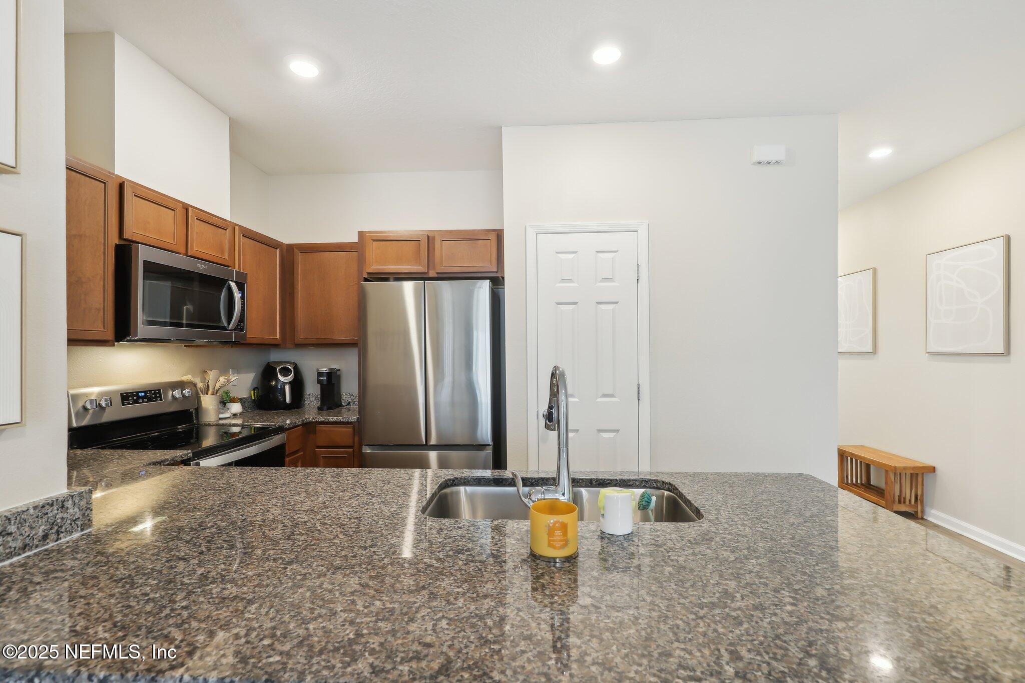 7738 Merchants Way Jacksonville, FL 32222 - Photo 13 of 29 a kitchen with stainless steel appliances granite countertop a refrigerator a stove and a sink