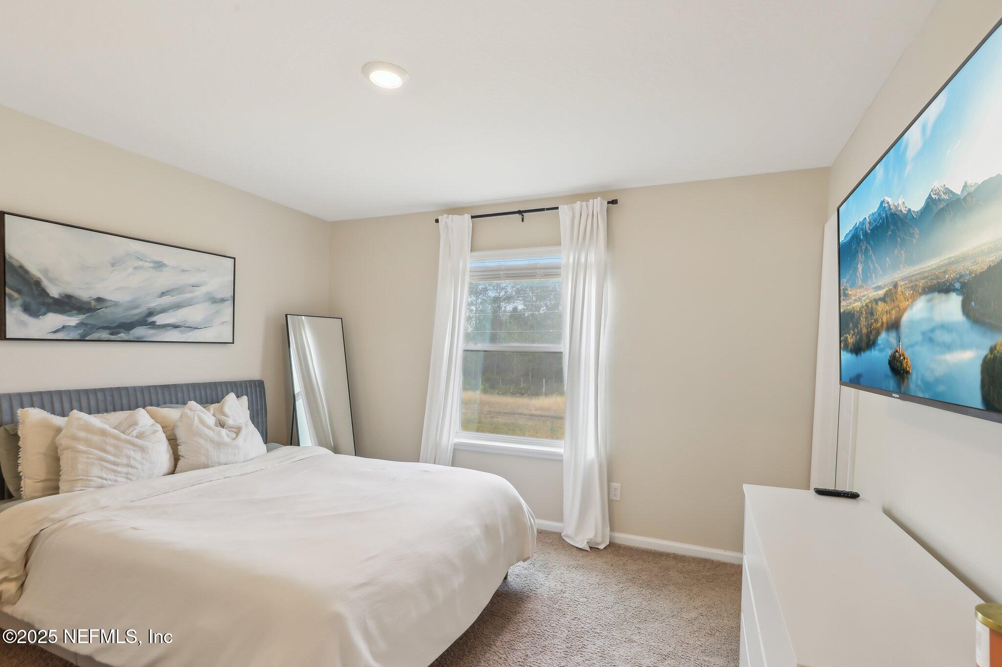 7738 Merchants Way Jacksonville, FL 32222 - Photo 14 of 29 a bedroom with a bed and a painting on the wall