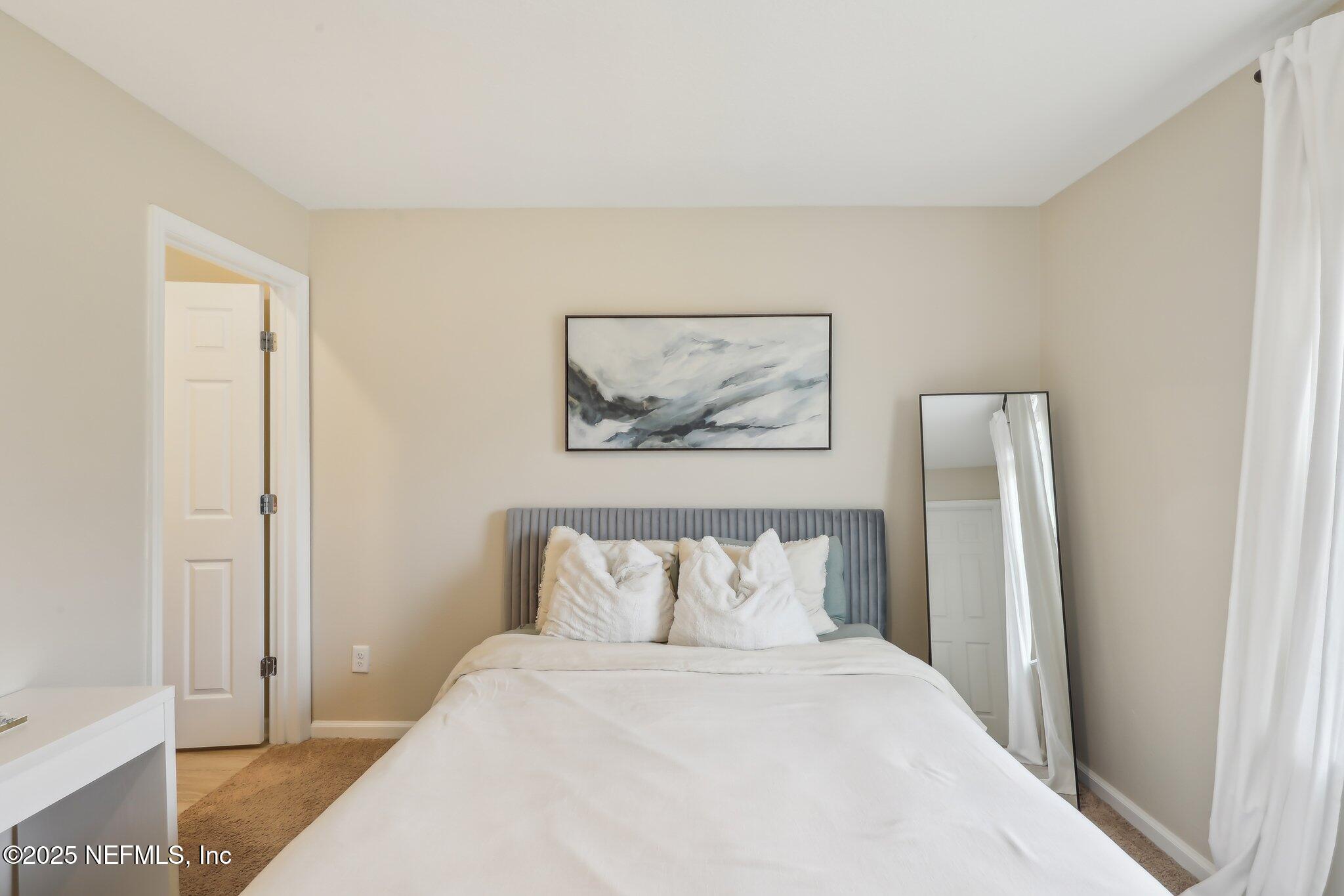 7738 Merchants Way Jacksonville, FL 32222 - Photo 15 of 29 a bedroom with a bed and a window