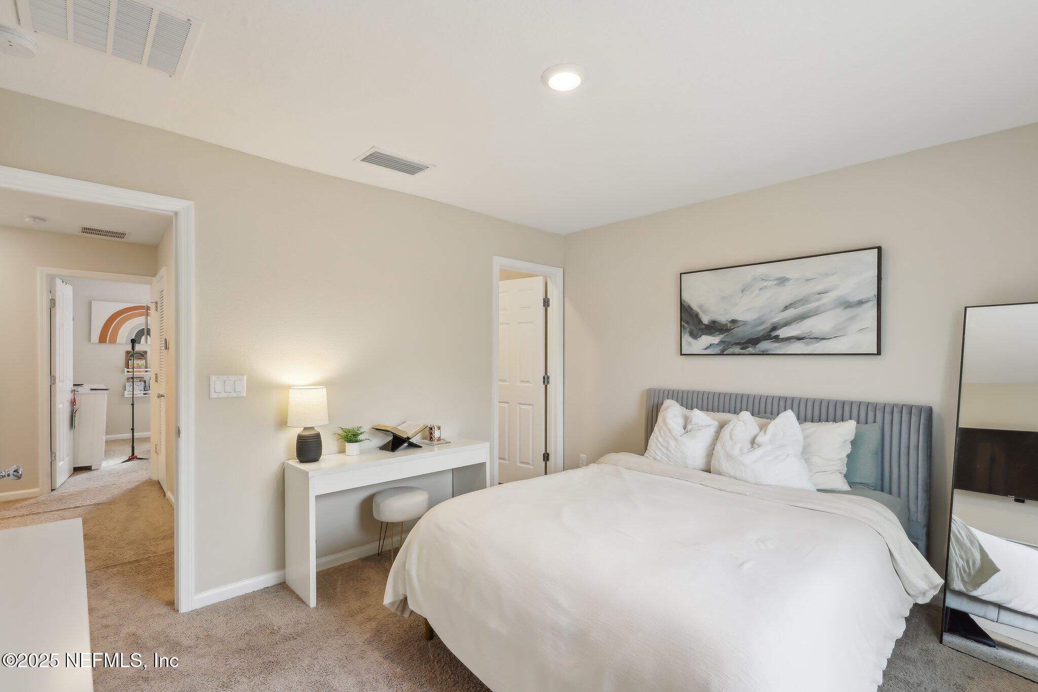 7738 Merchants Way Jacksonville, FL 32222 - Photo 16 of 29 a bedroom with a bed and a painting on the wall