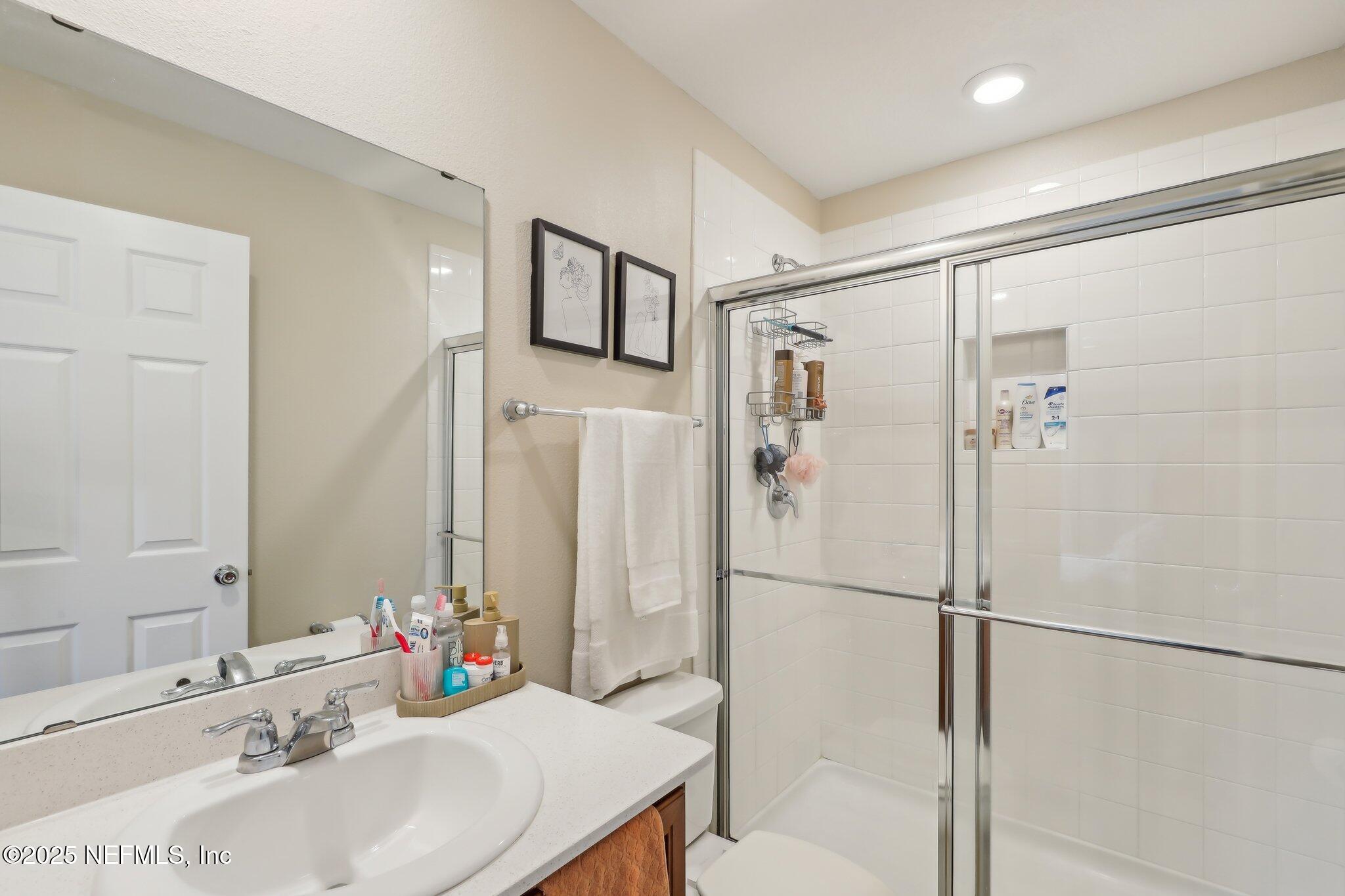 7738 Merchants Way Jacksonville, FL 32222 - Photo 18 of 29 a bathroom with a sink and a mirror
