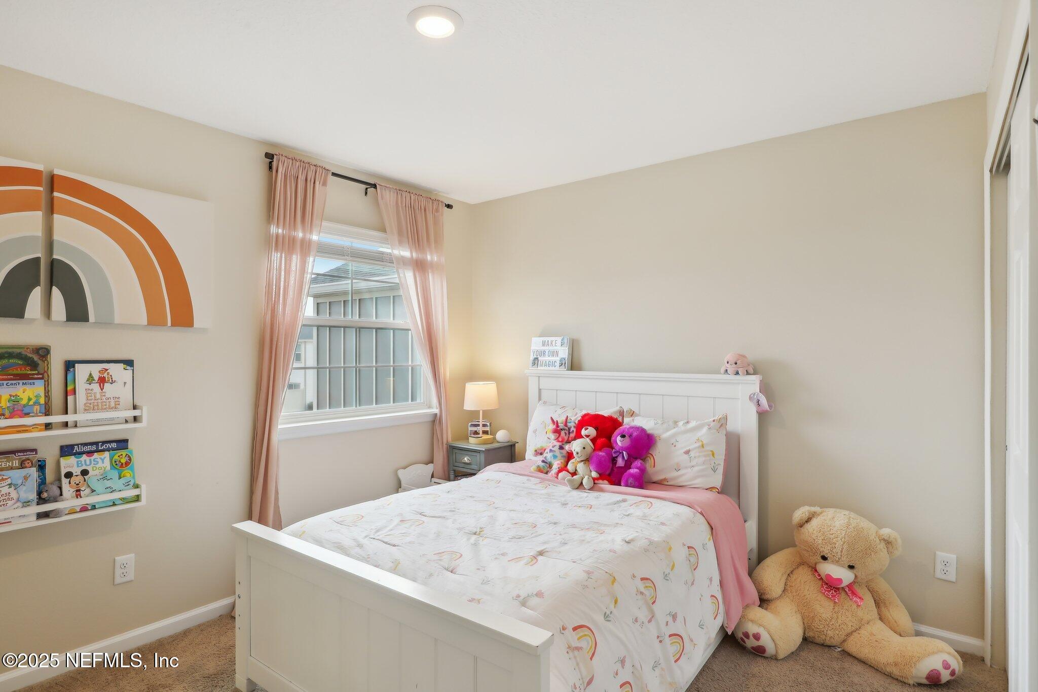 7738 Merchants Way Jacksonville, FL 32222 - Photo 19 of 29 a bedroom with a bed and a window