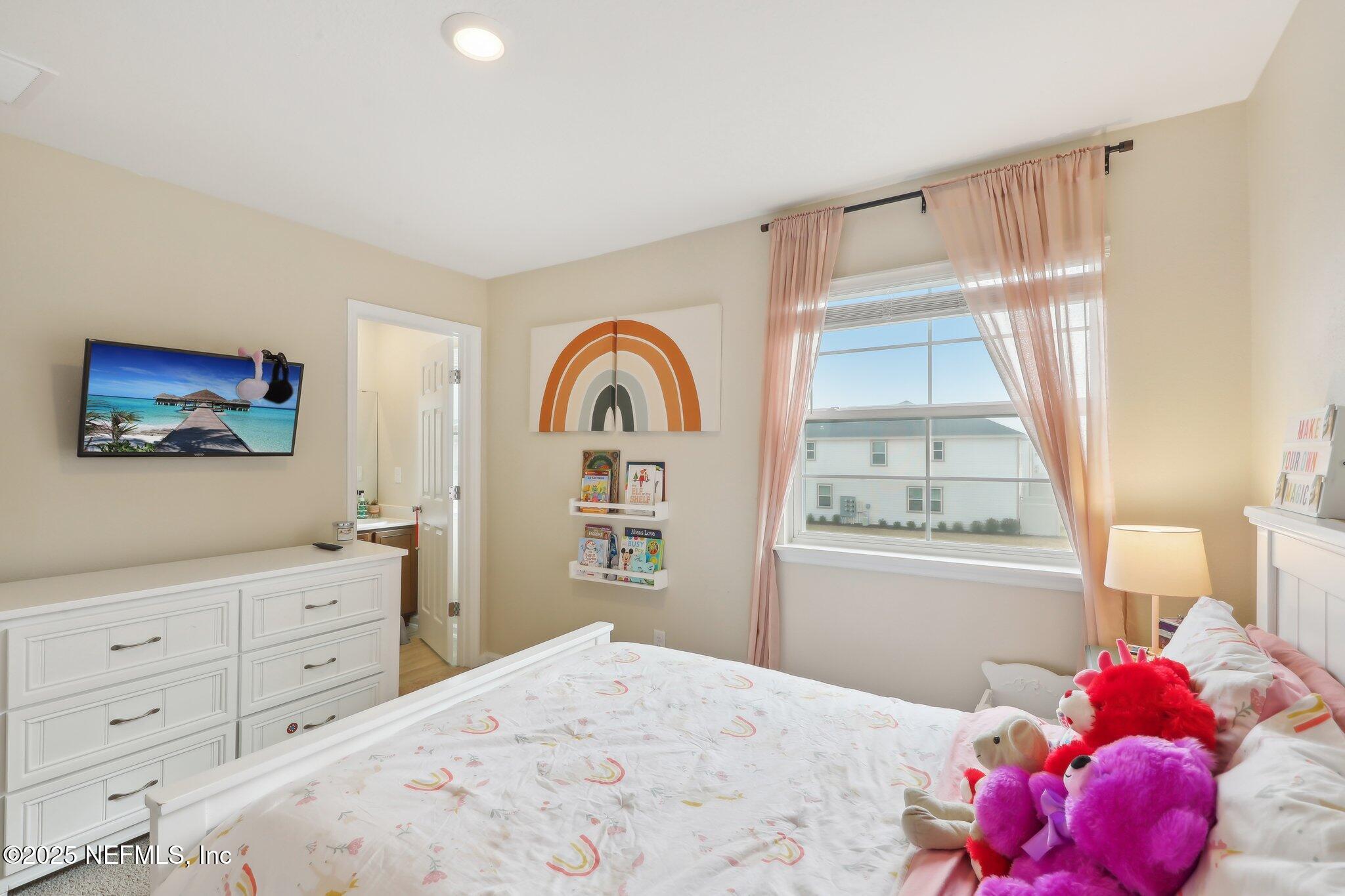 7738 Merchants Way Jacksonville, FL 32222 - Photo 20 of 29 a bedroom with a bed and a window