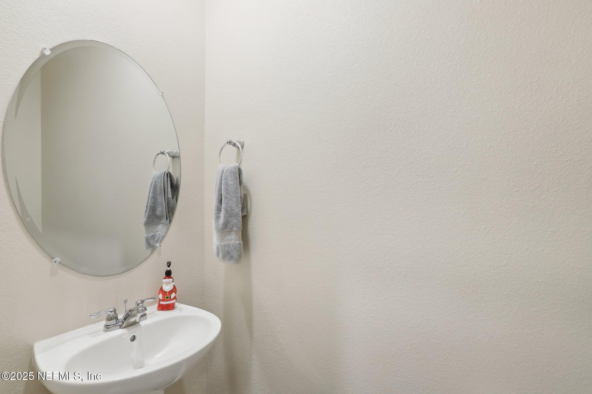 7738 Merchants Way Jacksonville, FL 32222 - Photo 22 of 29 a bathroom with a sink and a mirror
