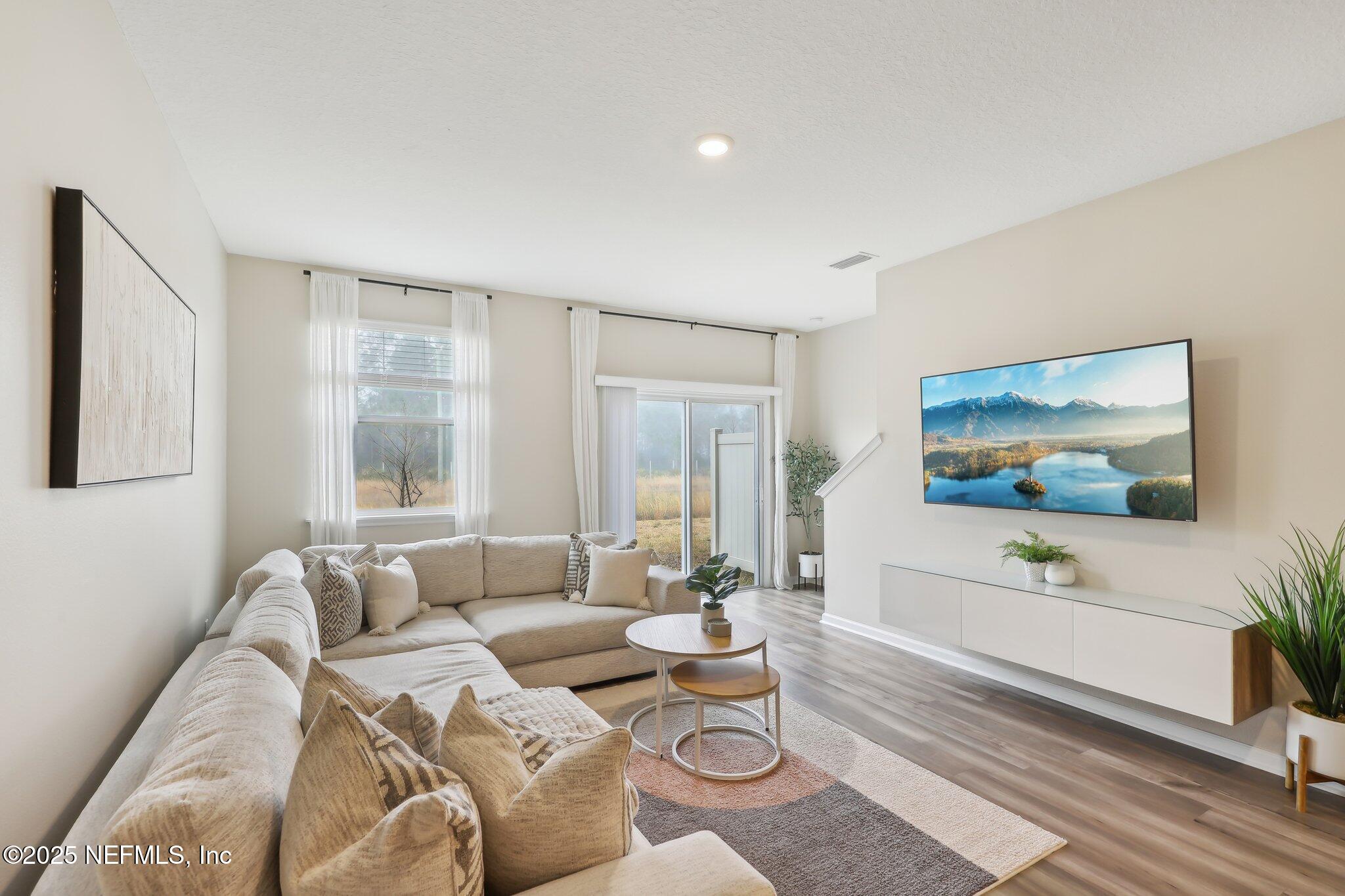 7738 Merchants Way Jacksonville, FL 32222 - Photo 7 of 29 a living room with furniture and a flat screen tv