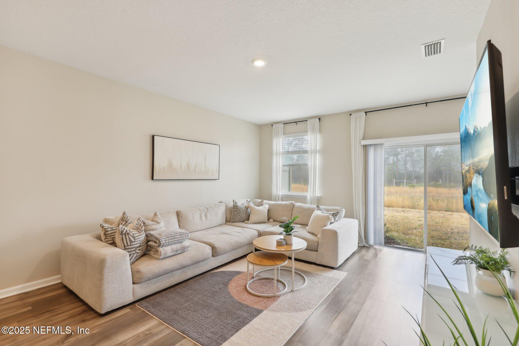 7738 Merchants Way Jacksonville, FL 32222 - Photo 8 of 29 a living room with furniture and a large window