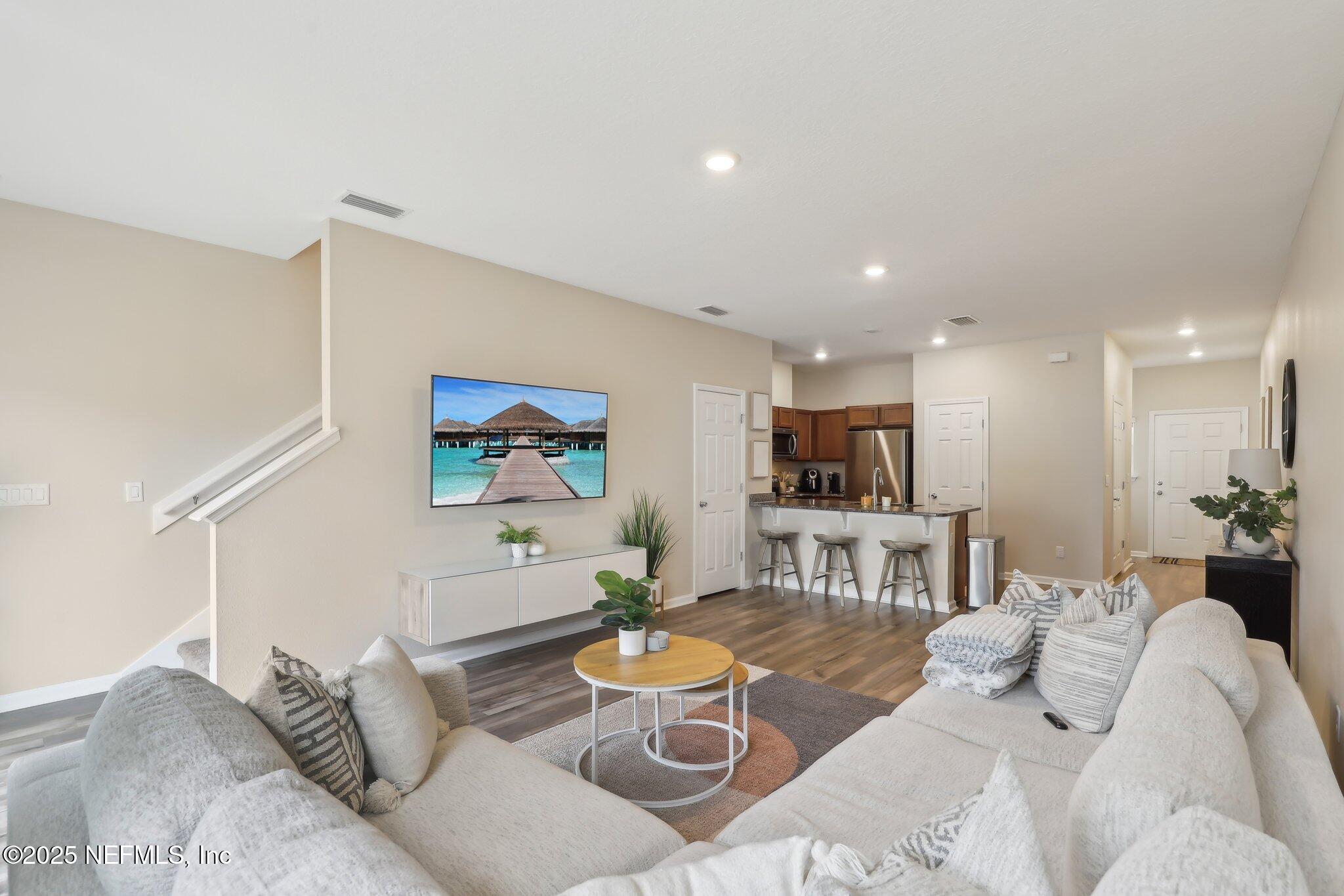 7738 Merchants Way Jacksonville, FL 32222 - Photo 10 of 29 a living room with furniture and a dining table with kitchen view
