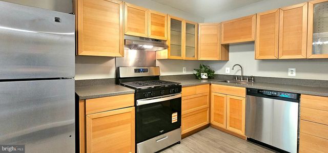 a kitchen with a stove and a refrigerator