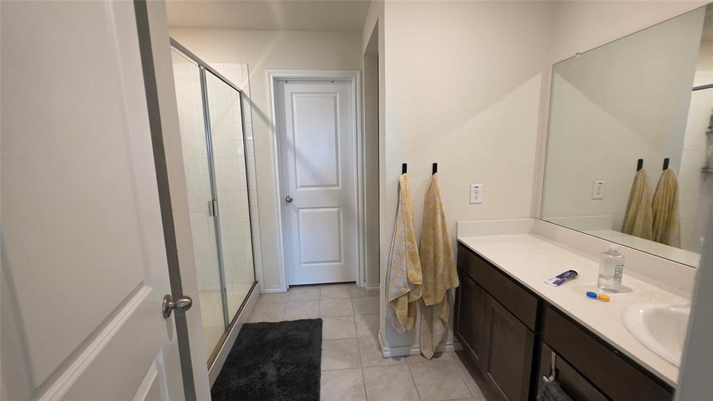 409 Samuel Street Denton, TX 76207 - Photo 30 of 40 a bathroom with a sink a toilet and a mirror