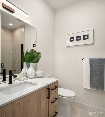 a bathroom with a toilet a sink and a mirror