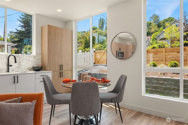 a dining room with furniture a window and wooden floor