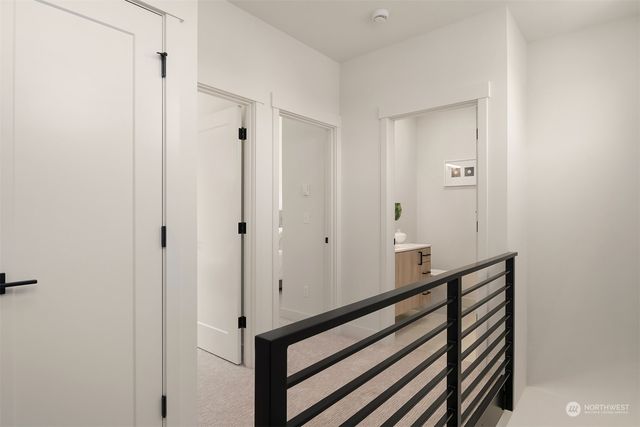 a view of a hallway with wooden floor and entryway
