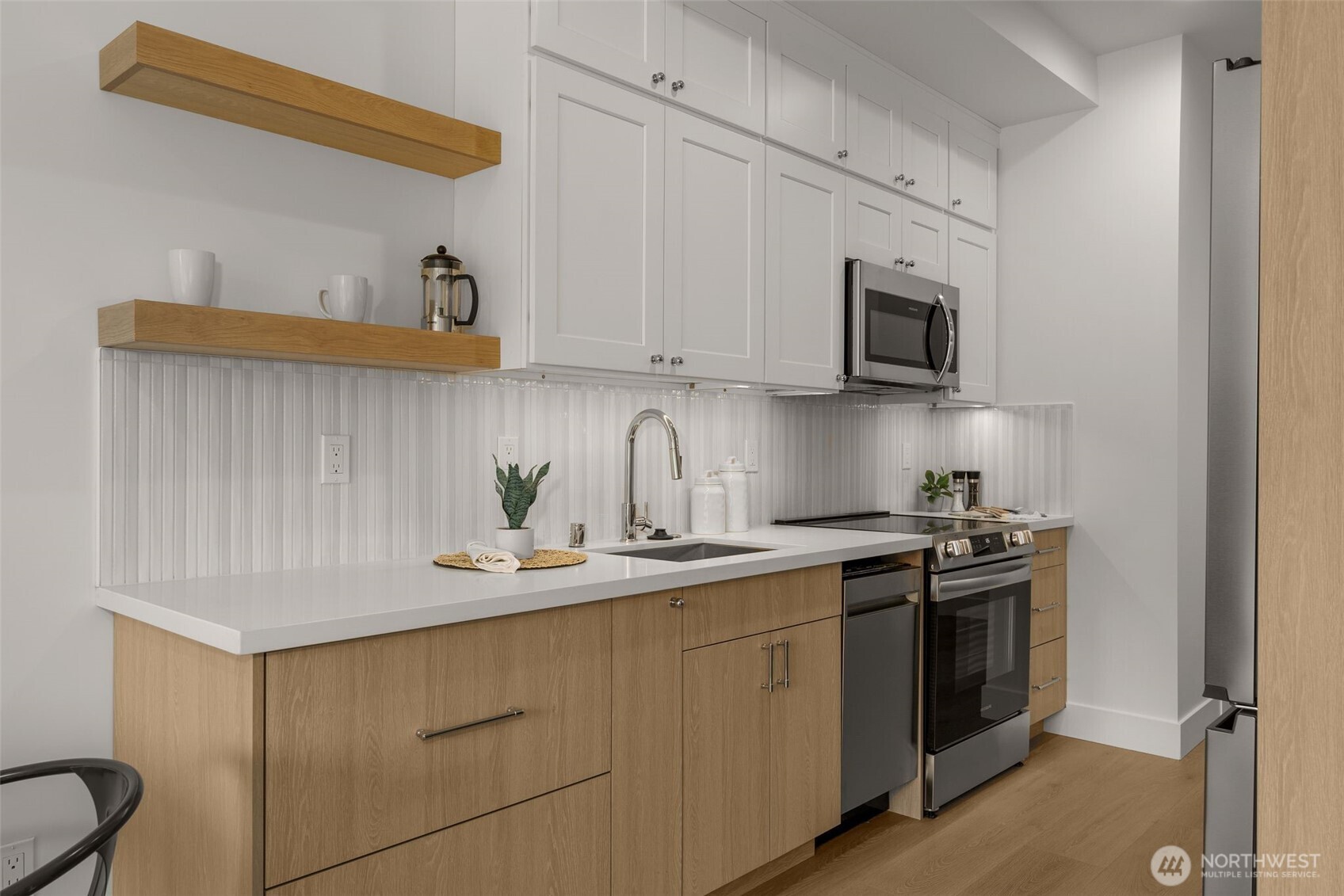 6249 Airport Way South, Unit B Seattle, WA 98108 - Photo 11 of 24 a kitchen with stainless steel appliances granite countertop a sink and a stove