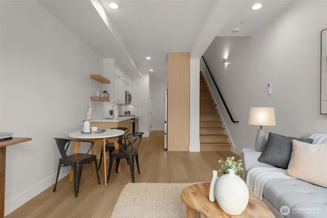 a living room with furniture and wooden floor