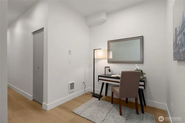 a bedroom with a bed lamp and a large window