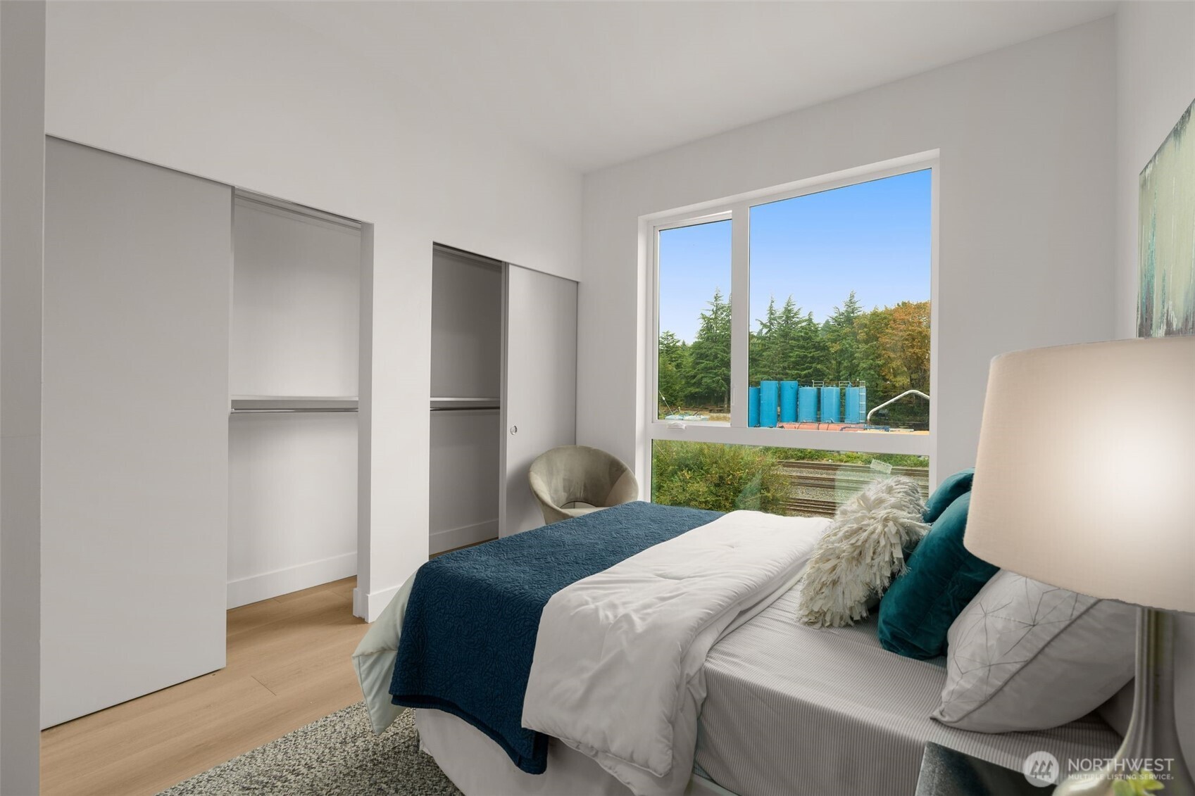 6249 Airport Way South, Unit B Seattle, WA 98108 - Photo 17 of 24 a bedroom with a bed lamp and a large window