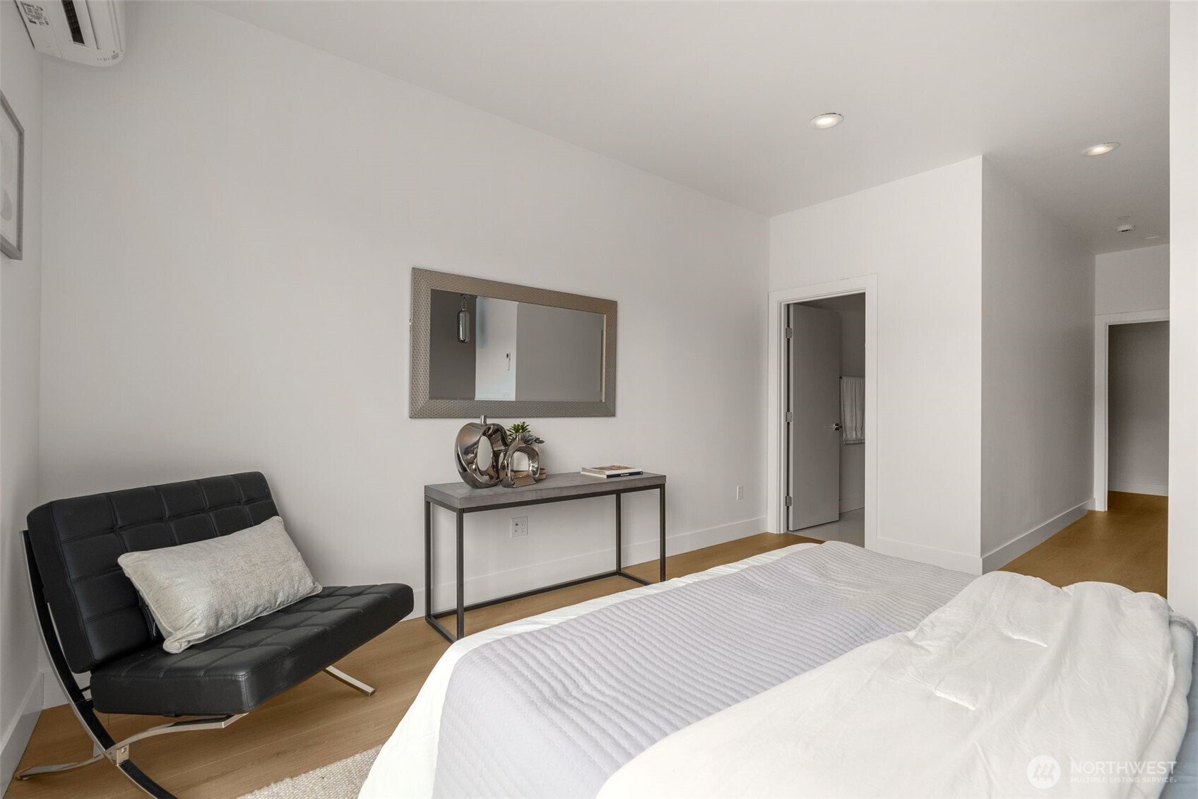 6249 Airport Way South, Unit B Seattle, WA 98108 - Photo 20 of 24 a bedroom with a bed and wooden floor