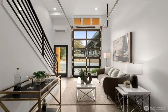 a dining room with furniture and a floor to ceiling window