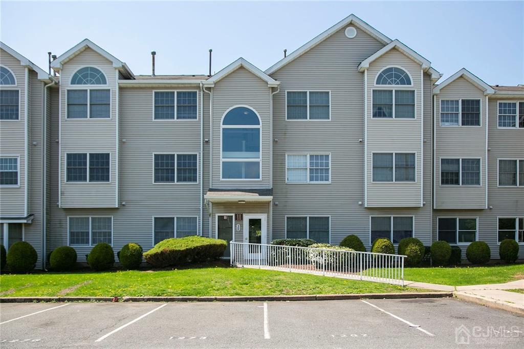 a front view of a residential apartment building with a yard