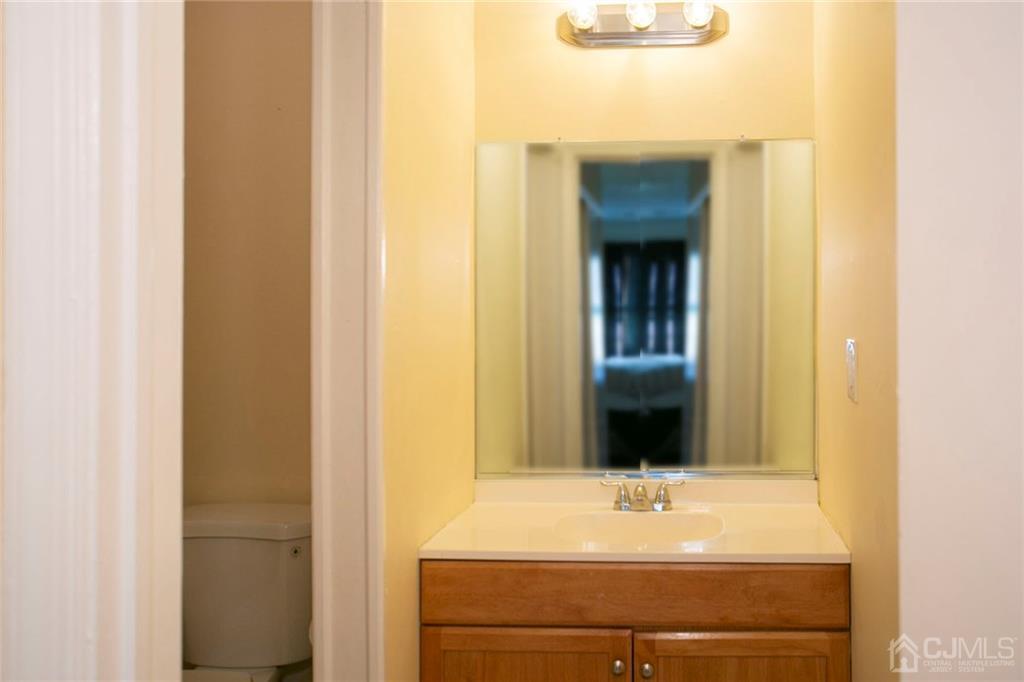 1213 Edpas Road New Brunswick, NJ 08901 - Photo 7 of 14 a view of a hallway with wooden cabinet and mirror