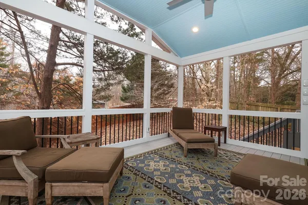 a living room with furniture and a floor to ceiling window