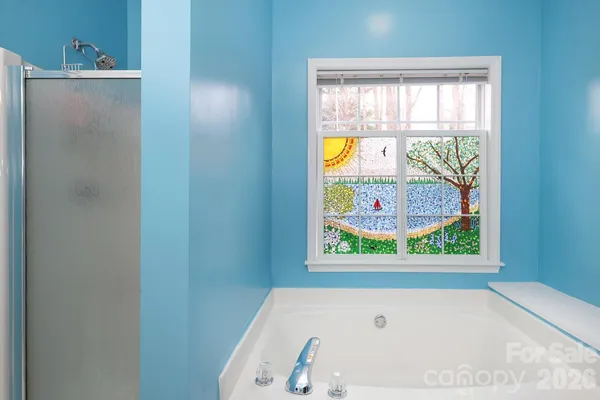 a bathroom with a tub and window