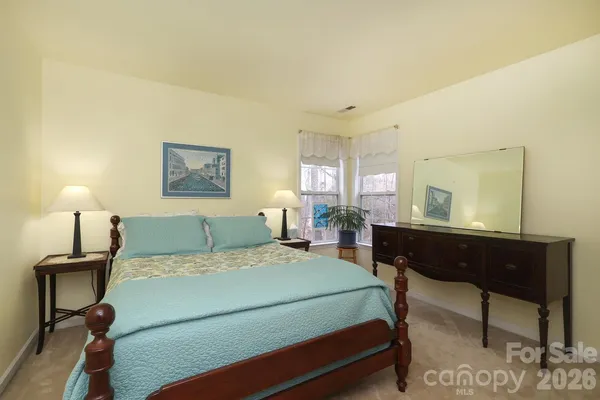 a bedroom with a bed and a table in it