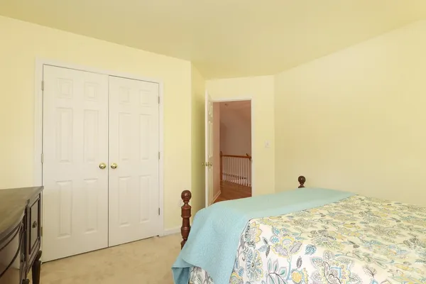 a bedroom with a bed and a cabinet
