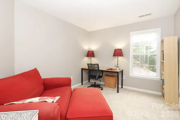 a bedroom with a bed and a desk