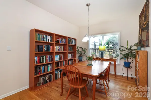 a view of a dining room with furniture and a book shelf