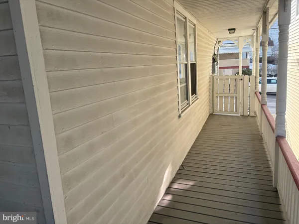 a view of a hallway with furniture and a window