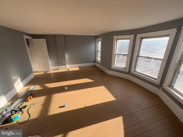 a view of a room with wooden floor and chair