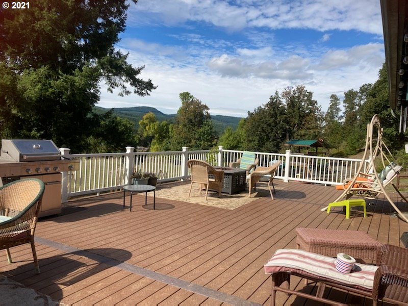 72010 London Road Cottage Grove, OR 97424 - Photo 27 of 31 a view of a chairs and table on the wooden deck