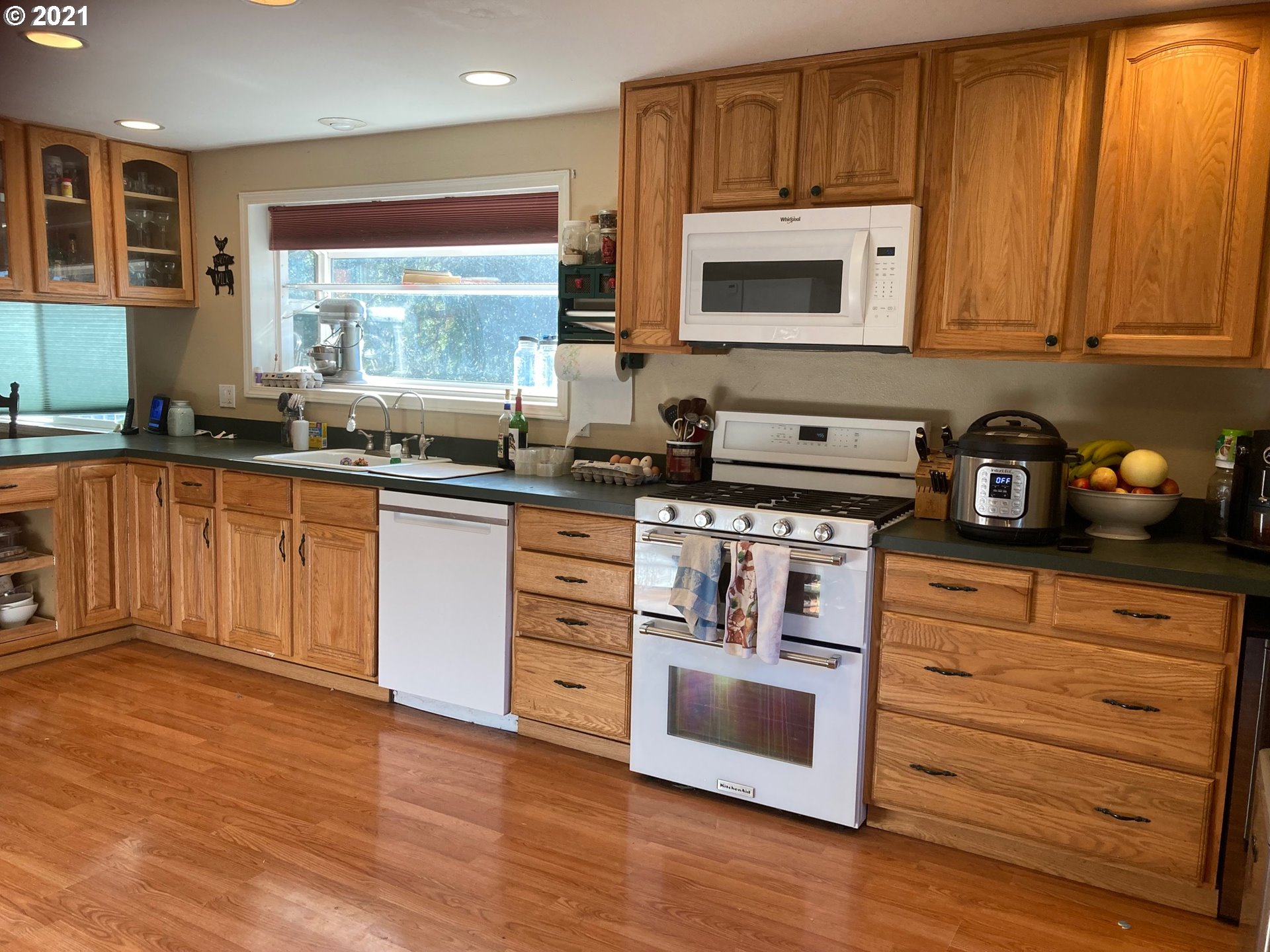 72010 London Road Cottage Grove, OR 97424 - Photo 5 of 31 a kitchen with stainless steel appliances granite countertop a stove a sink and a microwave
