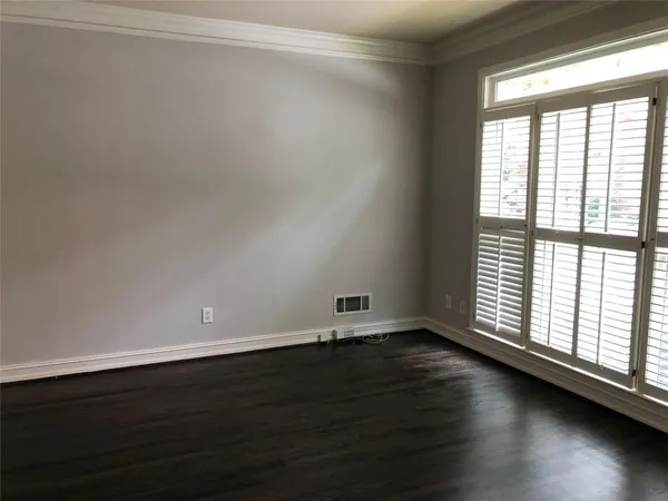 a view of a glass door with wooden floor and a window