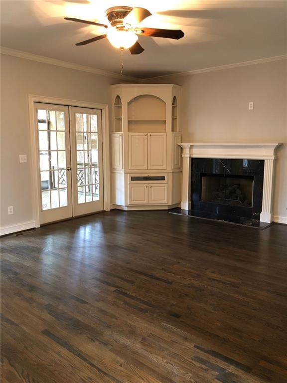2242 Lenox Walk Northeast Atlanta, GA 30319 - Photo 16 of 36 an empty room with wooden floor fireplace and windows