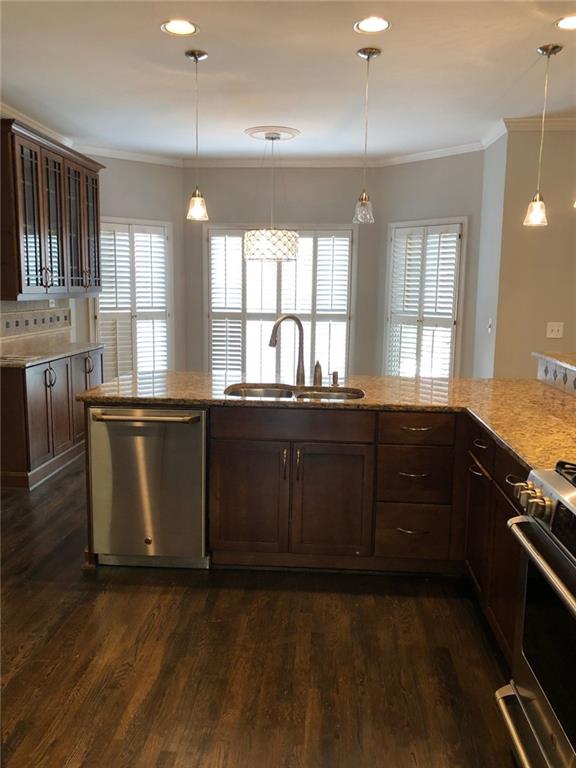 2242 Lenox Walk Northeast Atlanta, GA 30319 - Photo 17 of 36 a kitchen with stainless steel appliances granite countertop a sink a stove and wooden floors