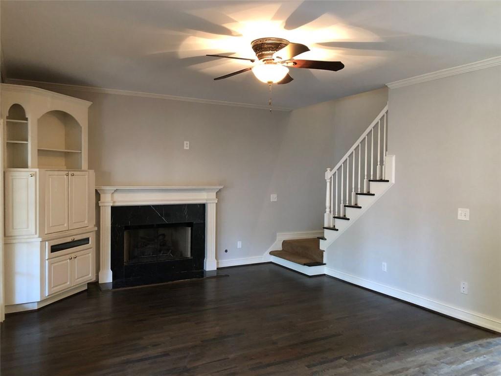2242 Lenox Walk Northeast Atlanta, GA 30319 - Photo 19 of 36 a view of an empty room with wooden floor fireplace and a window