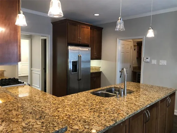 a living room with kitchen island granite countertop furniture and a fireplace