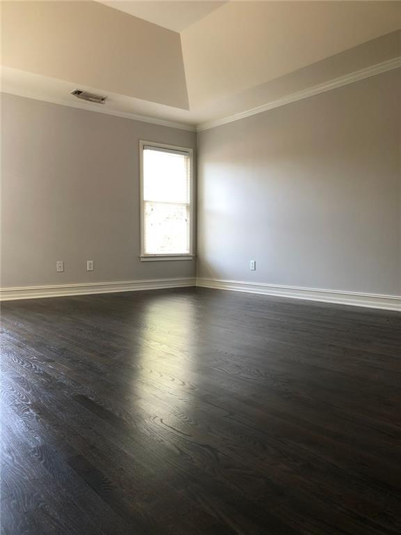 2242 Lenox Walk Northeast Atlanta, GA 30319 - Photo 30 of 36 an empty room with wooden floor and windows