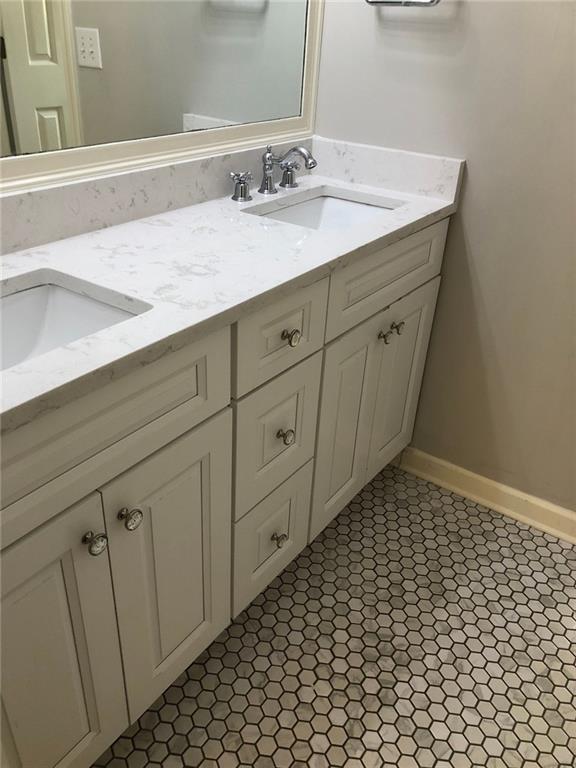 2242 Lenox Walk Northeast Atlanta, GA 30319 - Photo 33 of 36 a bathroom with a sink and a mirror