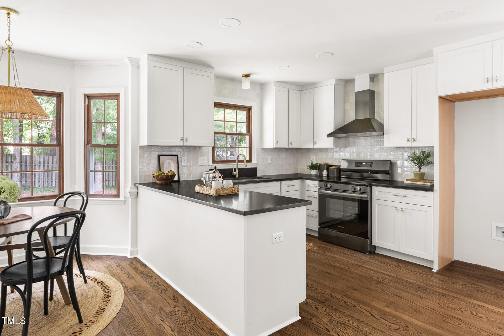 16 Cedar Hill Drive Durham, NC 27713 - Photo 19 of 35 a kitchen with stainless steel appliances granite countertop white cabinets a sink a stove a dining table and chairs