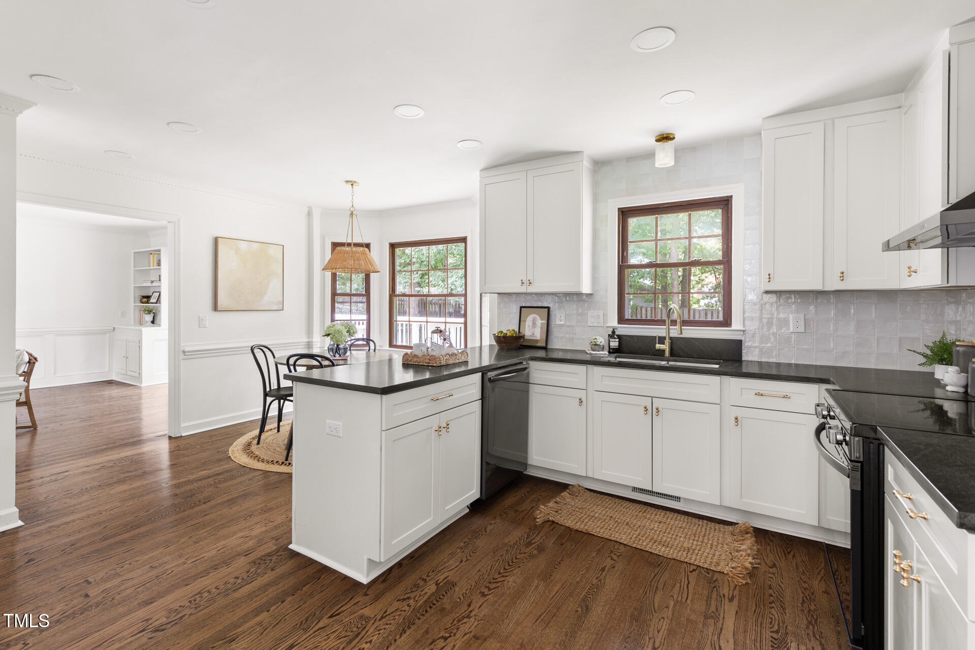 16 Cedar Hill Drive Durham, NC 27713 - Photo 20 of 35 a kitchen with stainless steel appliances granite countertop wooden floors and white cabinets