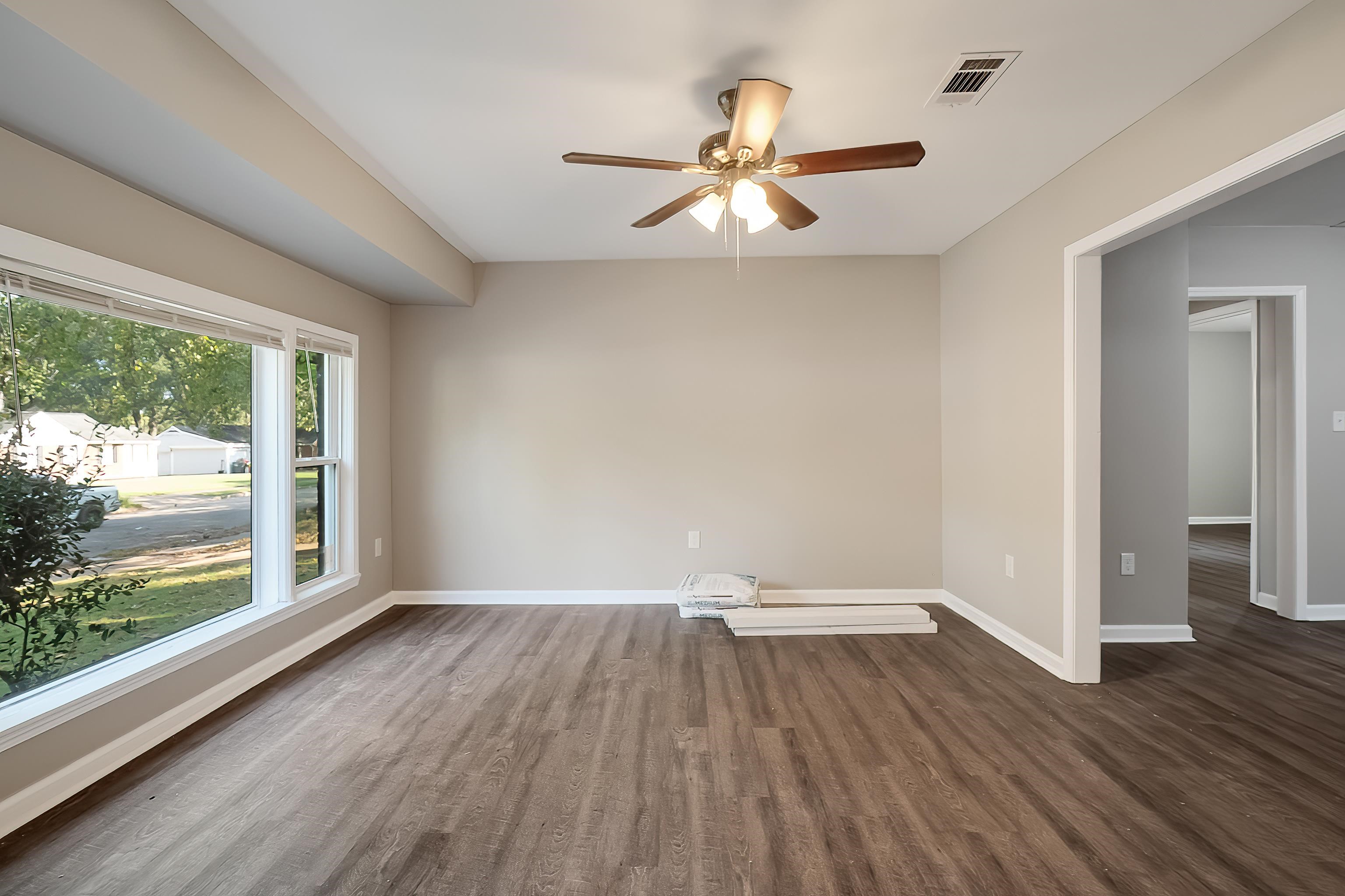 1019 Wingfield Road Memphis, TN 38122 - Photo 8 of 34 an empty room with wooden floor fan and windows