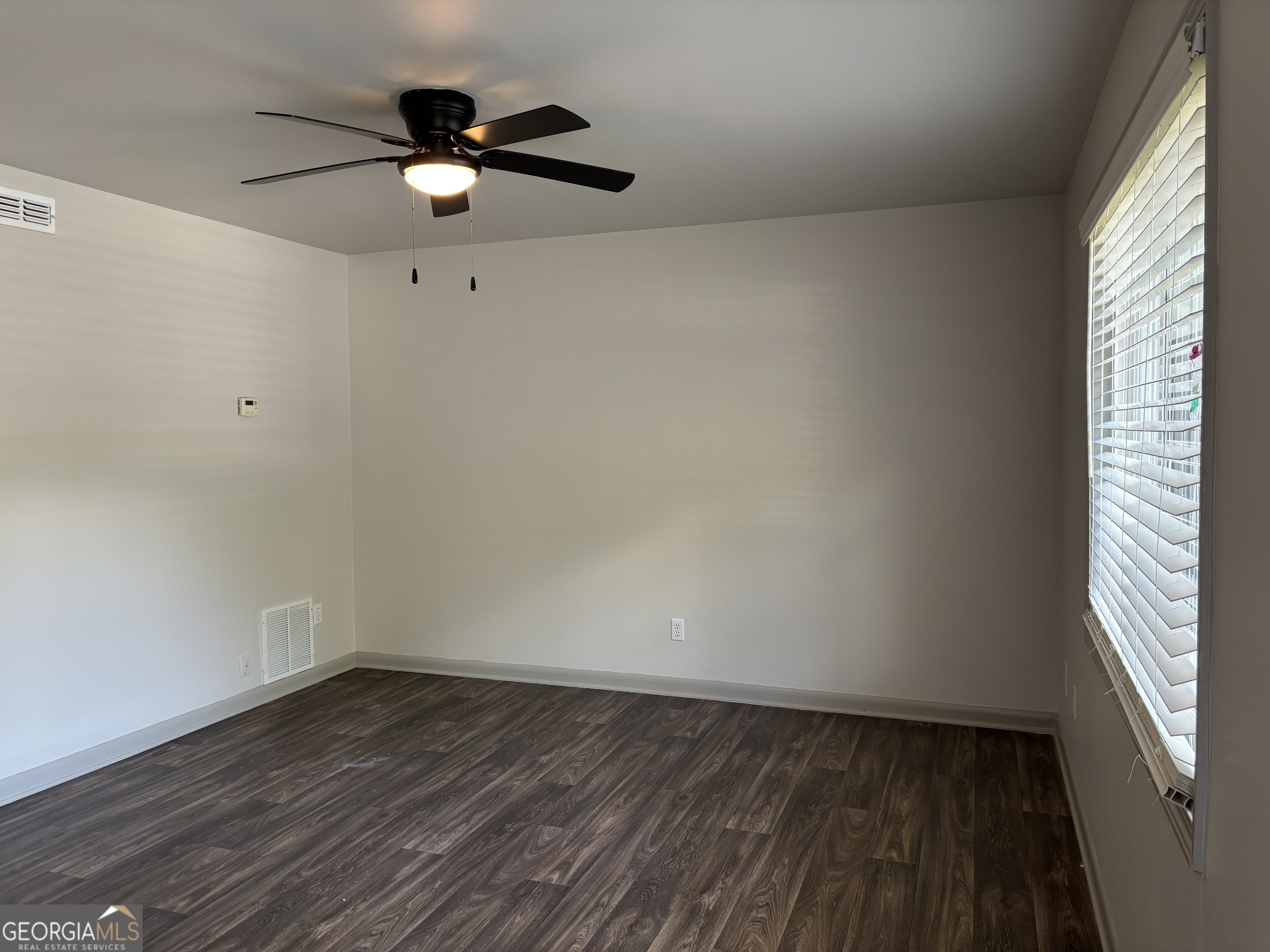 1609 Line Street Decatur, GA 30032 - Photo 2 of 15 a view of an empty room with wooden floor and a window