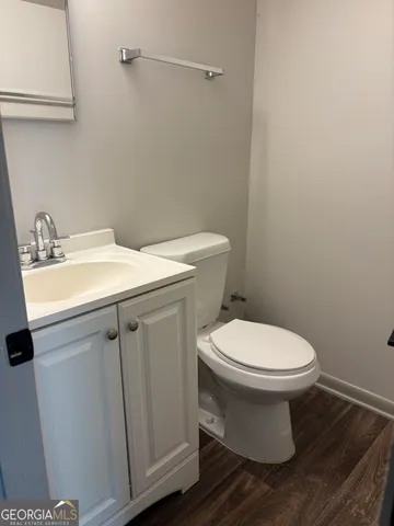 a white toilet sitting next to a bathroom sink