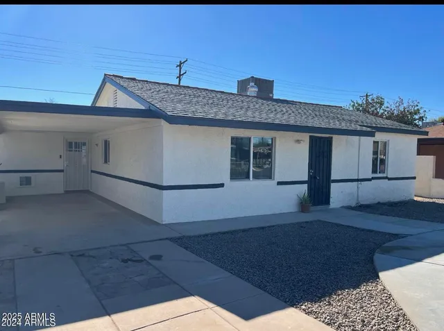 a view of backyard of house and entertaining space